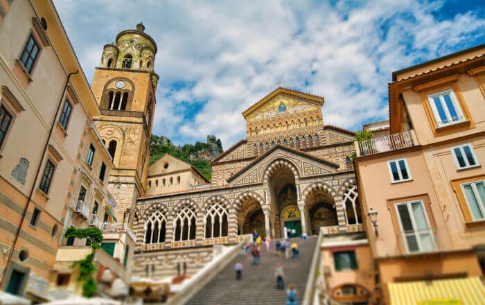 The magnificent Amalfi Cathedral, with its striking striped façade and grand staircase, standing as a symbol of history and faith in the heart of Amalfi, Italy.