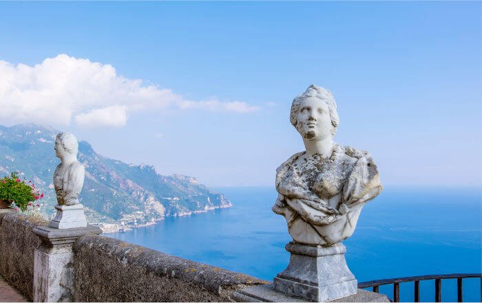 The iconic torso statues of the Terrazza dell’Infinito at Villa Cimbrone in Ravello, Italy, overlooking the endless horizon of the Amalfi Coast.